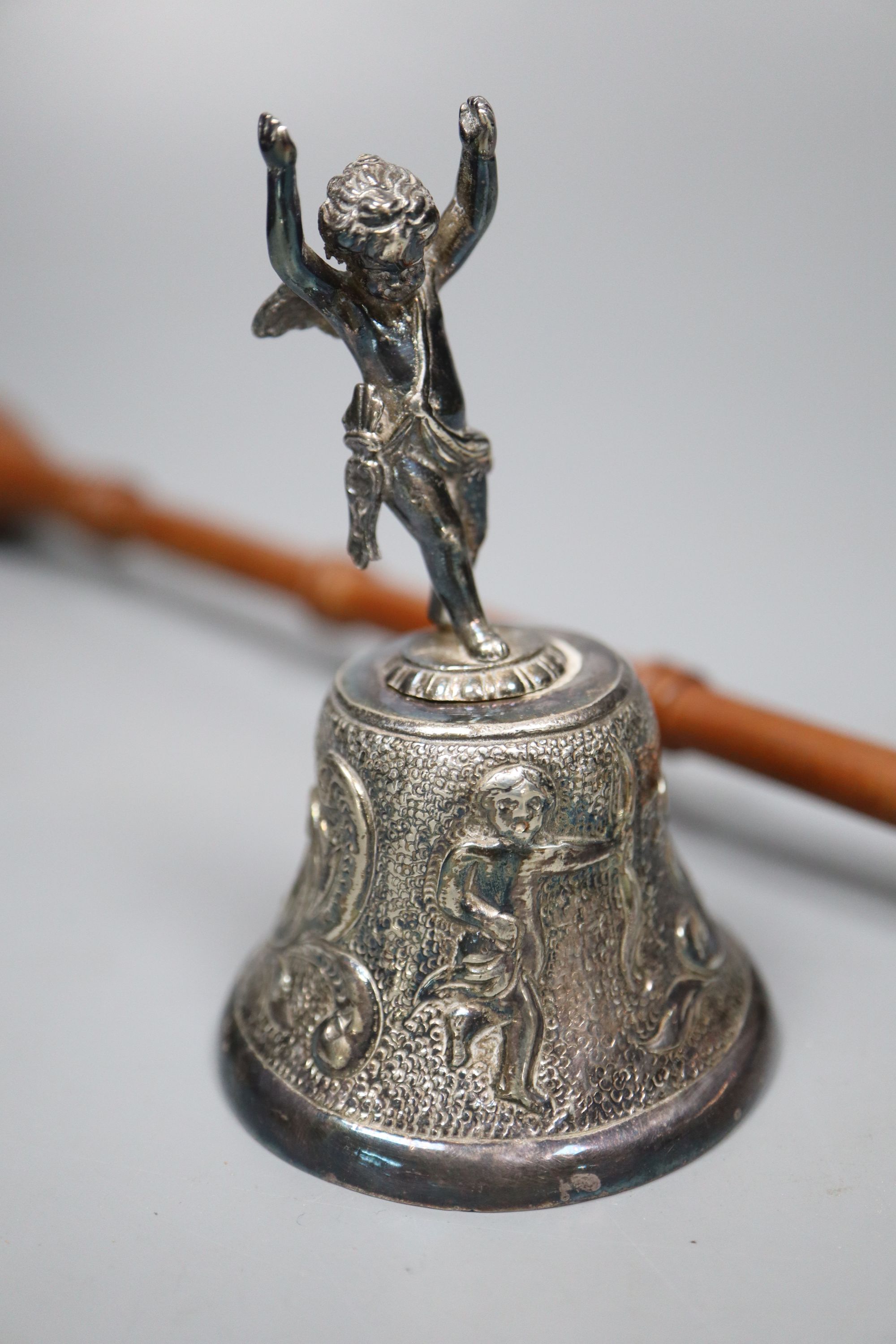 A modern silver table bell with putti handle, and a modern silver and turned wood handle candle snuffer,